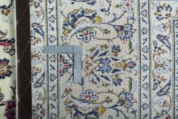 Backside of handmade 2000s Kashan rug showing knot structure and weave density