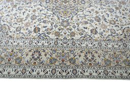 Corner detail of New Kashan rug showing border pattern and Wool pile
