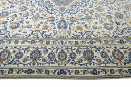 Corner detail of 2000s Kashan rug showing border pattern and Wool pile