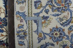 Backside of handmade 2000s Kashan rug showing knot structure and weave density