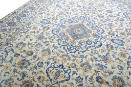 Backside of handmade 2000s Kashan rug showing knot structure and weave density