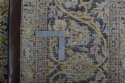 Backside of handmade New Kashan rug showing knot structure and weave density