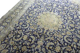 Backside of handmade New Kashan rug showing knot structure and weave density