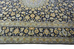 Corner detail of 2000s Kashan rug showing border pattern and Wool pile