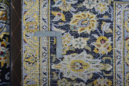 Backside of handmade 2000s Kashan rug showing knot structure and weave density