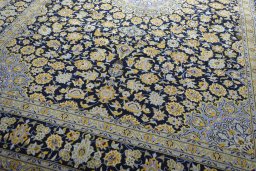 Close-up detail of 2000s Kashan rug from Iran / Persia showing Wool weave