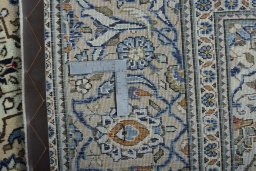 Backside of handmade New Kashan rug showing knot structure and weave density