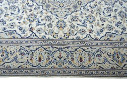 Corner detail of 2000s Kashan rug showing border pattern and Wool pile