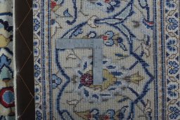 Backside of handmade 2000s Kashan rug showing knot structure and weave density