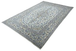 Corner detail of 2000s Kashan rug showing border pattern and Wool pile