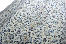 Backside of handmade 2000s Kashan rug showing knot structure and weave density