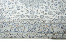 Corner detail of New Kashan rug showing border pattern and Wool pile