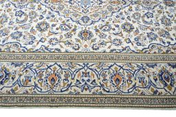 Corner detail of 2000s Kashan rug showing border pattern and Wool pile