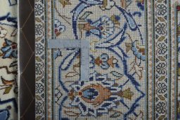 Backside of handmade 2000s Kashan rug showing knot structure and weave density