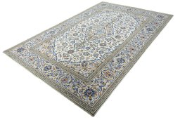 Corner detail of 2000s Kashan rug showing border pattern and Wool pile