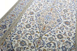 Backside of handmade 2000s Kashan rug showing knot structure and weave density