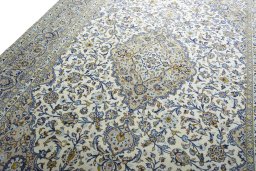 Backside of handmade 2000s Kashan rug showing knot structure and weave density