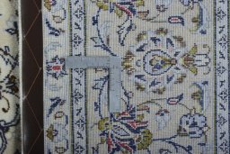 Backside of handmade New Kashan rug showing knot structure and weave density