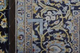 Backside of handmade 2000s Kashan rug showing knot structure and weave density