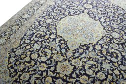 Backside of handmade 2000s Kashan rug showing knot structure and weave density