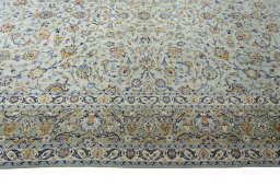 Corner detail of 2000s Kashan rug showing border pattern and Wool pile