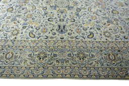 Corner detail of 2000s Kashan rug showing border pattern and Wool pile
