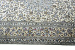 Corner detail of New Kashan rug showing border pattern and Wool pile