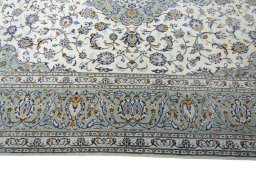 Corner detail of 2000s Kashan rug showing border pattern and Wool pile