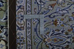 Backside of handmade 2000s Kashan rug showing knot structure and weave density