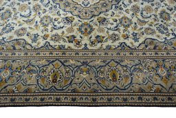 Corner detail of 2000s Kashan rug showing border pattern and Wool pile