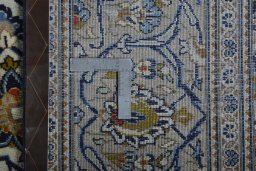 Backside of handmade 2000s Kashan rug showing knot structure and weave density