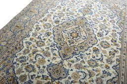 Backside of handmade 2000s Kashan rug showing knot structure and weave density