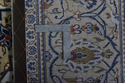 Backside of handmade New Kashan rug showing knot structure and weave density