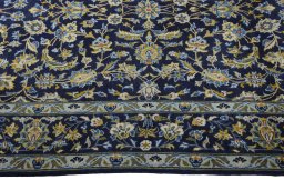 Corner detail of 2000s Kashan rug showing border pattern and Wool pile