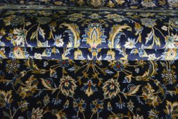 Close-up detail of 2000s Kashan rug from Iran / Persia showing Wool weave