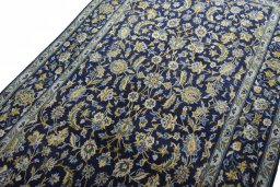 Backside of handmade 2000s Kashan rug showing knot structure and weave density