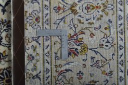Backside of handmade New Kashan rug showing knot structure and weave density