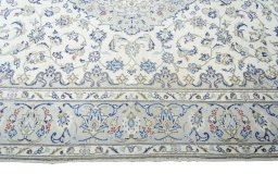 Corner detail of 2000s Kashan rug showing border pattern and Wool pile