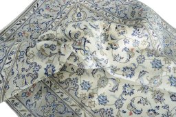 Backside of handmade 2000s Kashan rug showing knot structure and weave density
