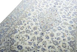 Backside of handmade 2000s Kashan rug showing knot structure and weave density