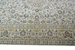 Corner detail of 2000s Kashan rug showing border pattern and Wool pile