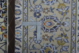 Backside of handmade 2000s Kashan rug showing knot structure and weave density