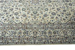 Corner detail of New Kashan rug showing border pattern and Wool pile