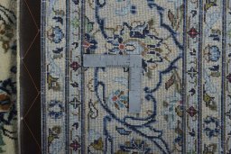 Backside of handmade New Kashan rug showing knot structure and weave density