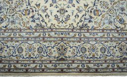 Full view of New Kashan rug from Iran / Persia, 315 × 205 cm in Beige tones