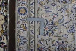 Backside of handmade New Kashan rug showing knot structure and weave density