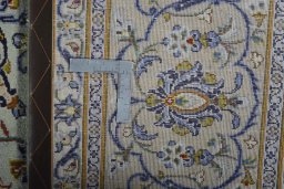 Backside of handmade 2000s Kashan rug showing knot structure and weave density