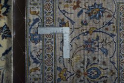 Backside of handmade New Kashan rug showing knot structure and weave density