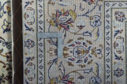 Backside of handmade New Kashan rug showing knot structure and weave density