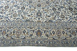 Corner detail of 2000s Kashan rug showing border pattern and Wool pile